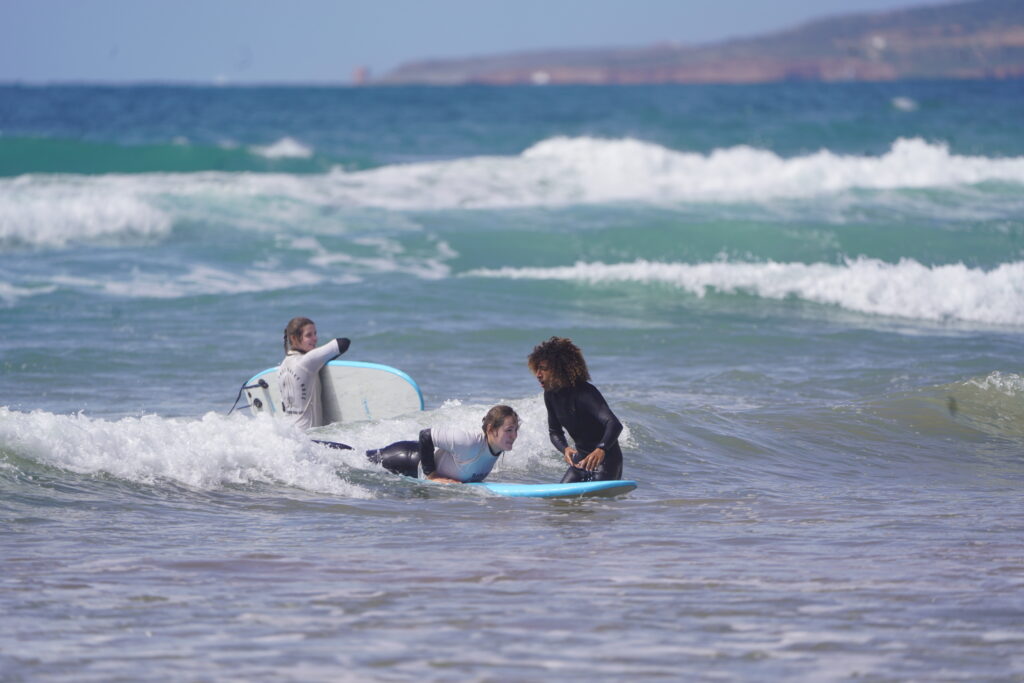 Surf instructor teaching guest surfing in Morocco